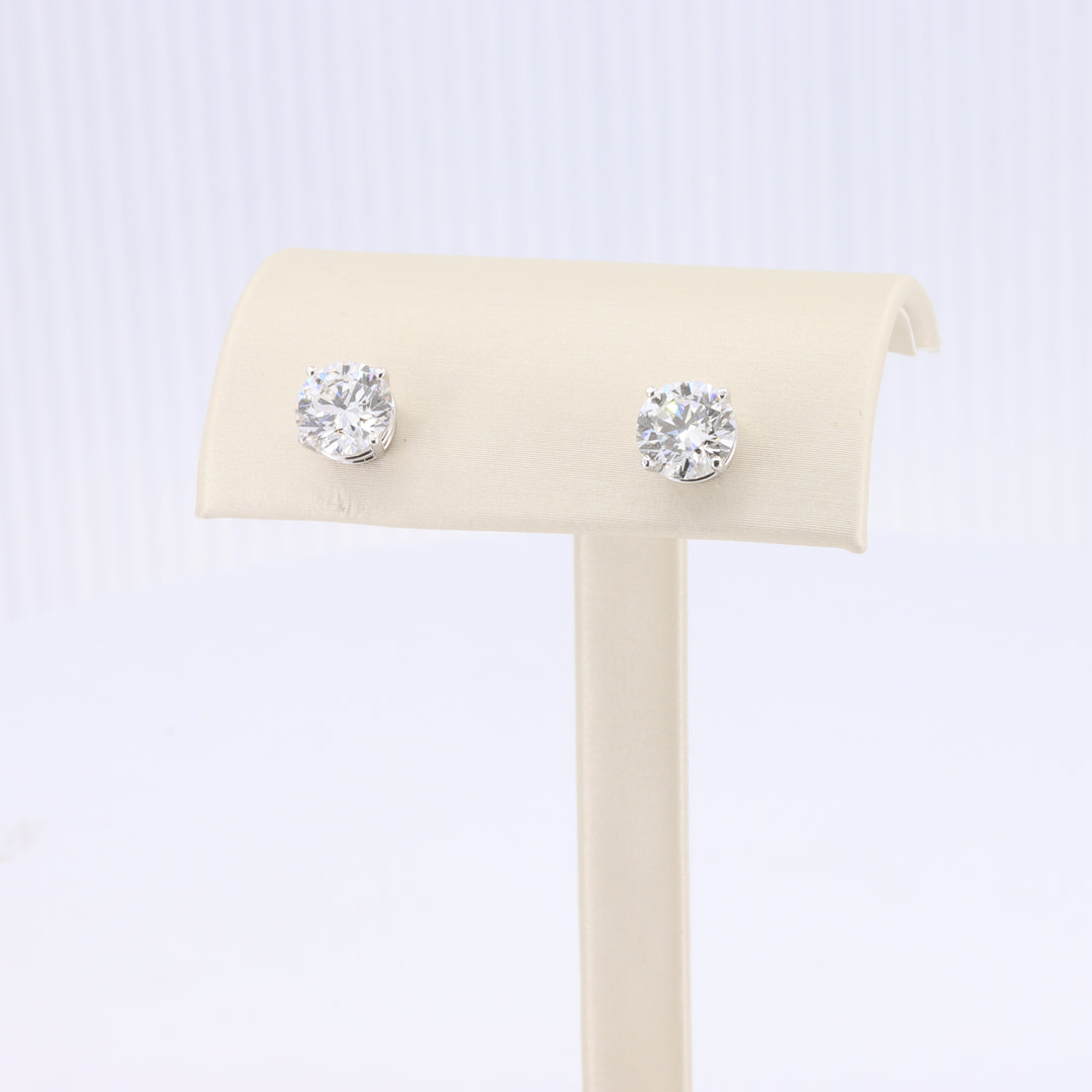 Sterling silver stud earrings featuring round, brilliant-cut clear cubic zirconia stones.