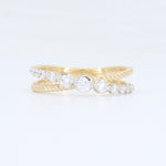 Load image into Gallery viewer, Gold twisted band ring with clear cubic zirconia stones, featuring an elegant, intertwined design.