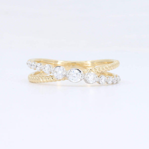 Elegant gold twist ring featuring sparkling clear cubic zirconia stones, perfect for stacking or as an engagement ring.