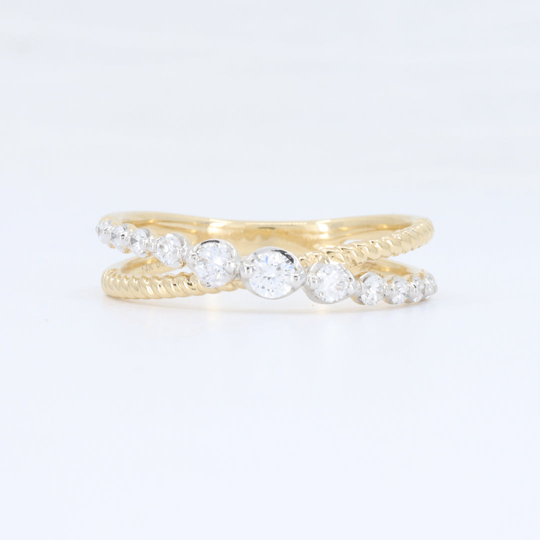 Gold twisted band ring with clear cubic zirconia stones, featuring an elegant, intertwined design.