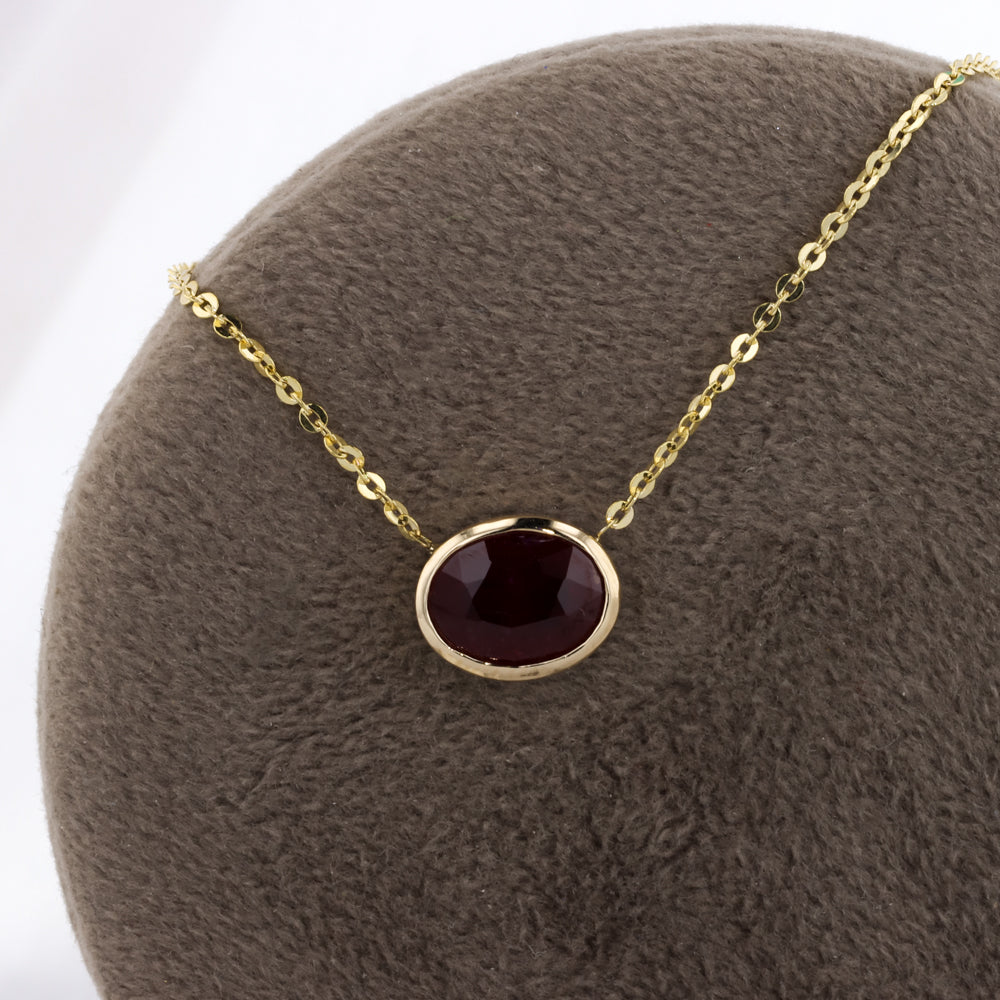 Bezel Set Oval Ruby Necklace in Yellow Gold