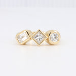 Load image into Gallery viewer, Bezel Set Three Stone Engagement Ring with an Emerald Cut, Round and Princess Cut Diamond
