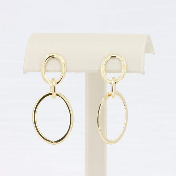 Gold-tone hoop earrings with interlocking circular designs, perfect for a modern, chic look.