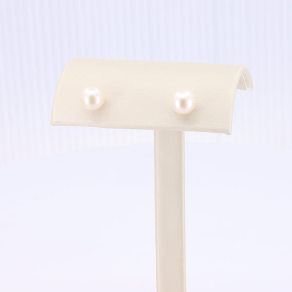 Freshwater Pearl Stud Earrings, 7mm, set of 2 ivory pearls on a cream display stand