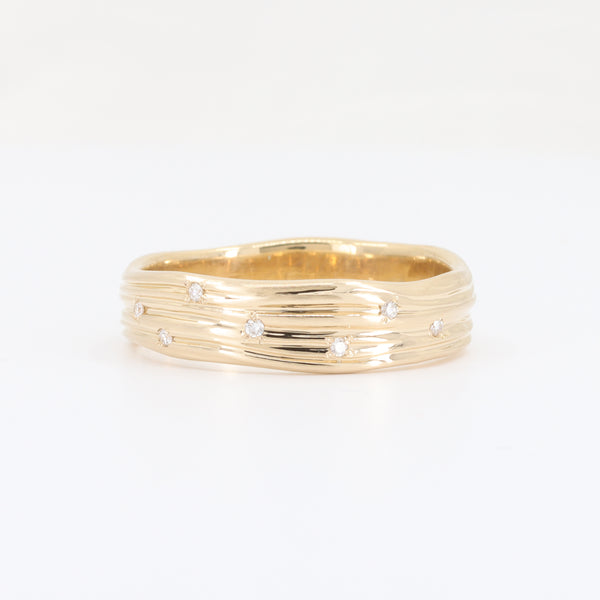 CAD-KCJ women's yellow gold diamond wedding band with a petite, textured wood-like surface and small diamonds