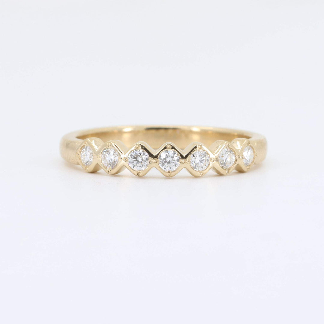 Gold stacking ring with alternating round and marquise-cut diamonds, elegant design, perfect for any occasion.