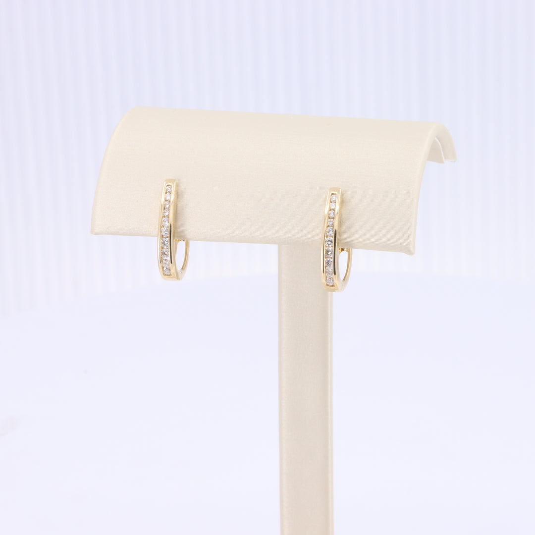 Channel Set Diamond Oval Huggie Earrings in Yellow Gold