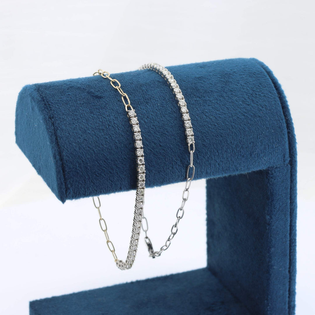 Gold and silver diamond bracelet set on a blue velvet display stand, showcasing elegant link and pave styles.