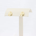 Load image into Gallery viewer, Gold teardrop earrings, polished finish, showcase modern elegance on a display stand. Perfect for any occasion.