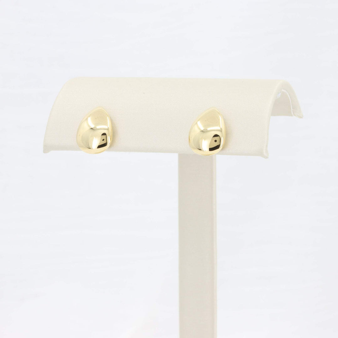 Gold teardrop earrings, polished finish, showcase modern elegance on a display stand. Perfect for any occasion.