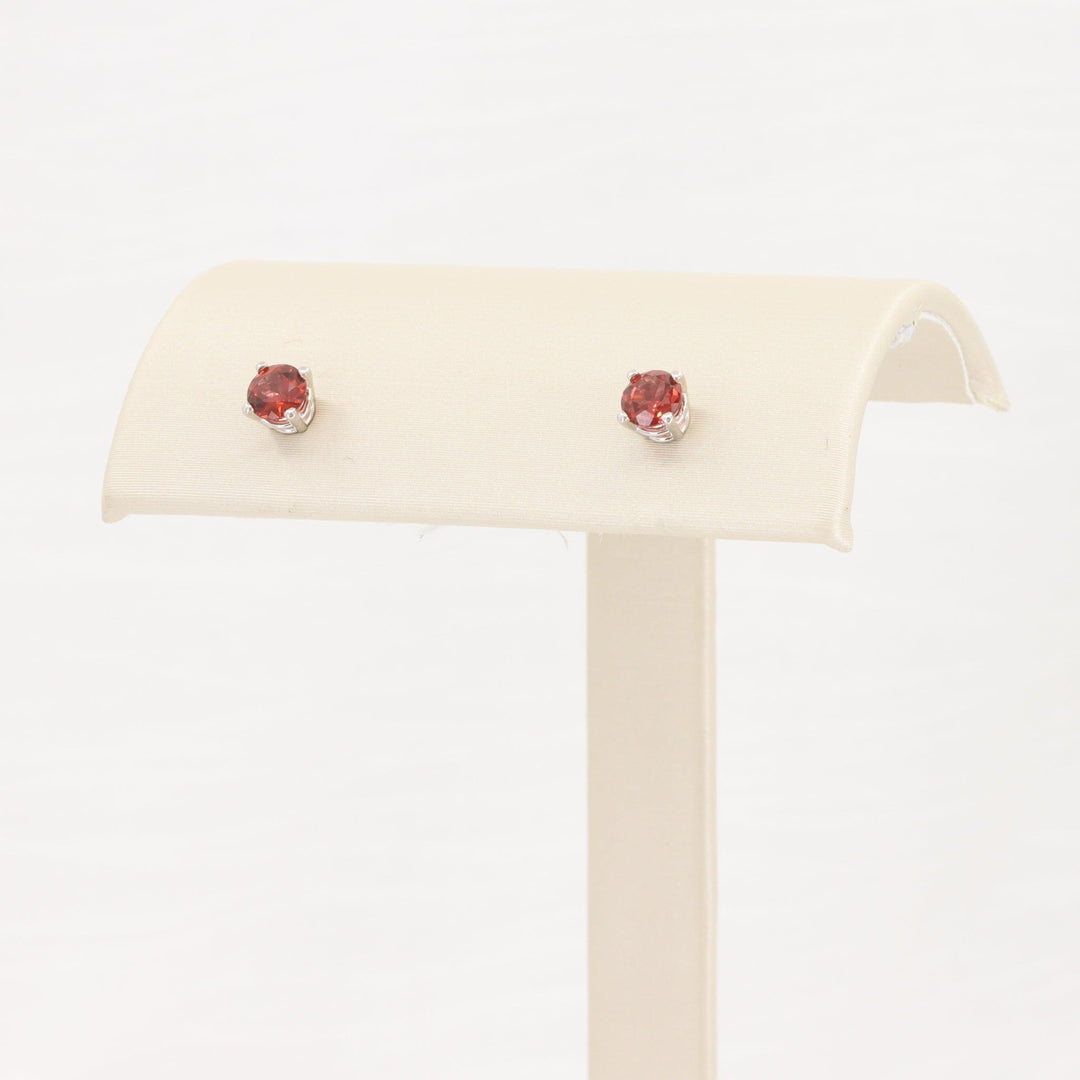 Red gemstone stud earrings in silver setting, elegant and perfect for everyday wear or special occasions.