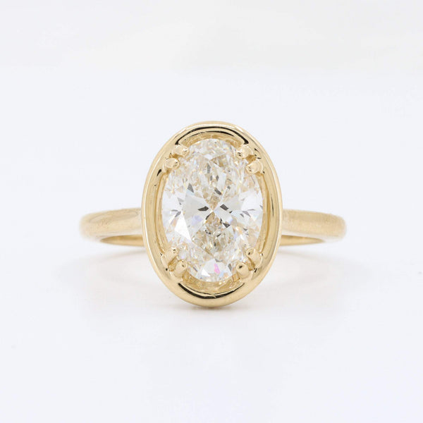 Oval diamond ring in 14K yellow gold, featuring a sparkling center stone with a classic, elegant design.