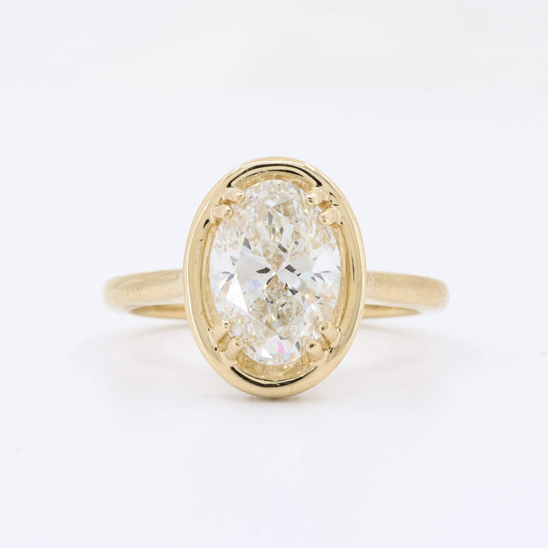 Oval diamond ring in 14K yellow gold, featuring a sparkling center stone with a classic, elegant design.