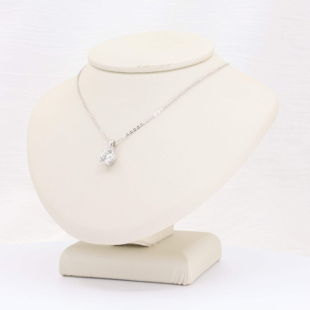 Elegant sterling silver necklace with a sparkling cubic zirconia pendant on a display bust.