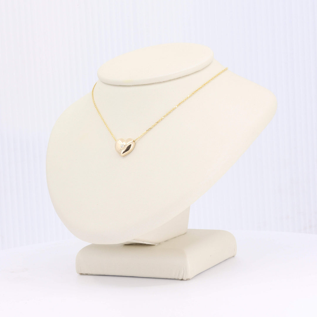 Elegant gold heart necklace with a sparkling diamond, perfect for gifting or personal wear.