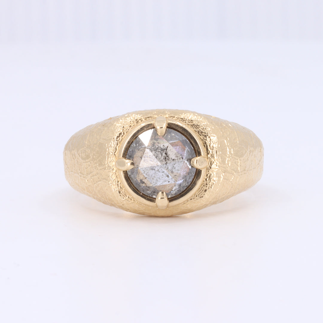 Gold textured ring featuring a round, faceted gray diamond centerpiece, elegant unisex design.