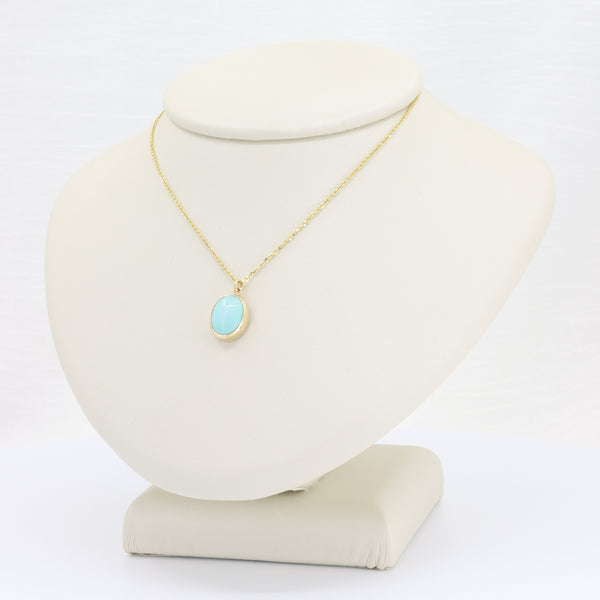 Turquoise cabochon bezel pendant on yellow gold chain, 18 inches