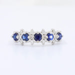 Load image into Gallery viewer, Elegant silver band ring with blue sapphires and shimmering diamonds, perfect for any occasion.