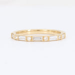 Load image into Gallery viewer, Elegant gold band ring with baguette and round diamonds, perfect for stacking or as a wedding band.